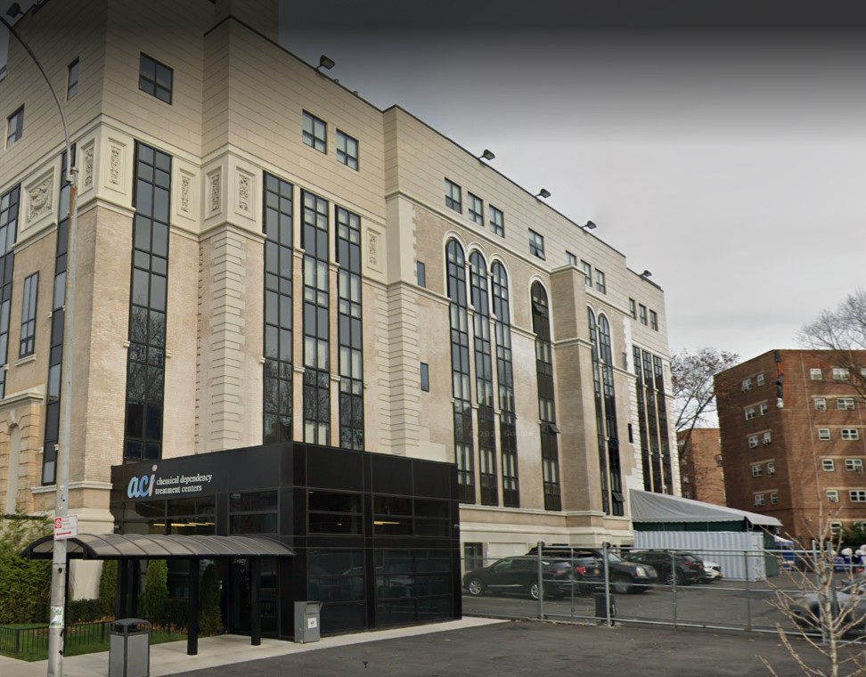  A building with tall windows and entrance signage.