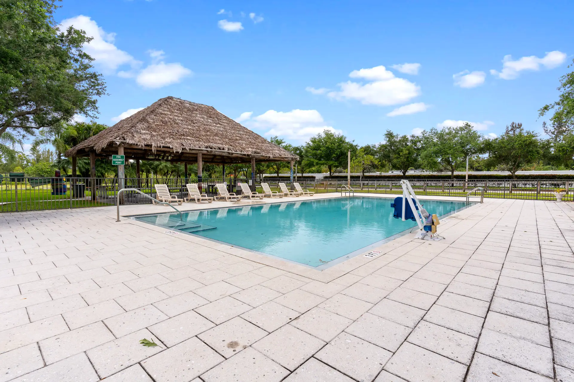 Rehab pool with lounge chairs and tiki-style shelter