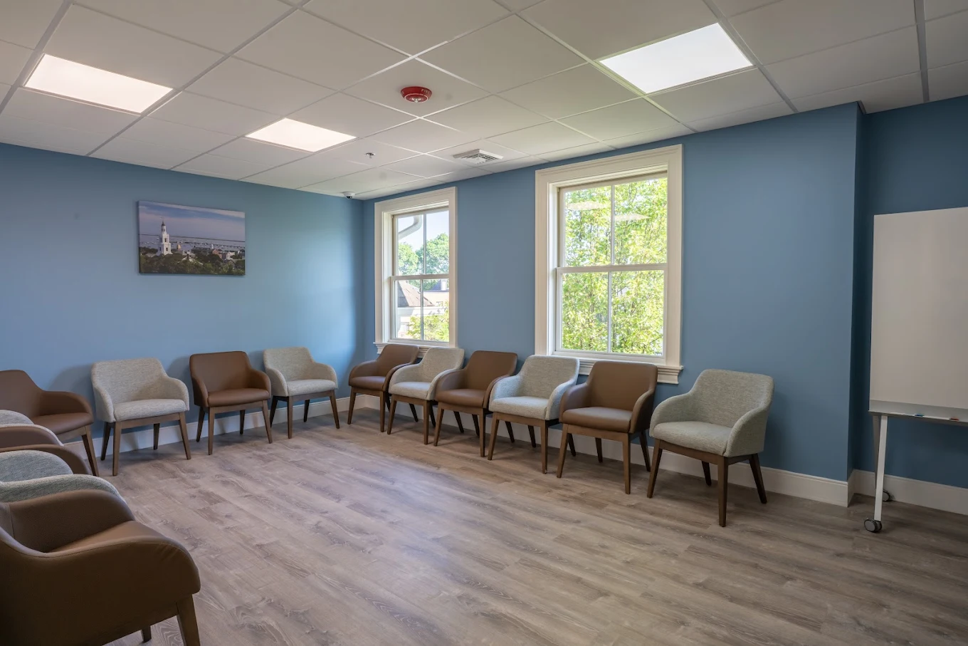 Group therapy room with circle of chairs and whiteboard