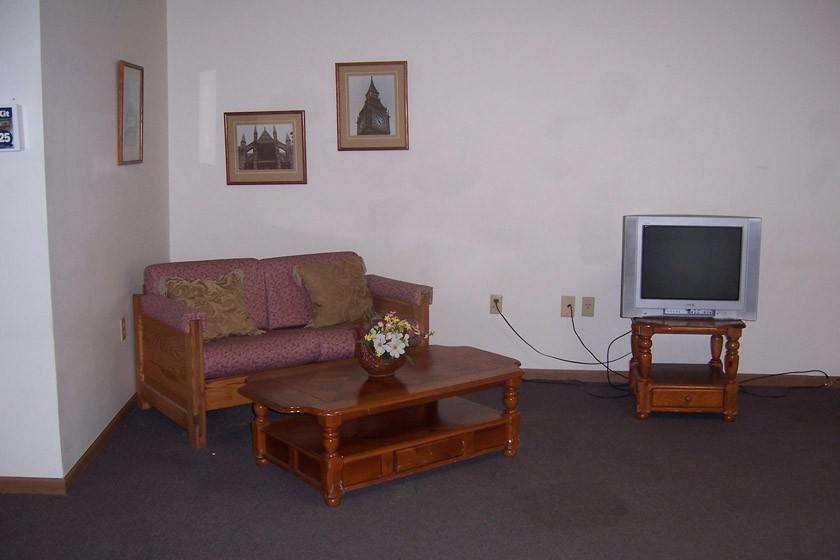 Rehab lounge with sofa, TV, and coffee table