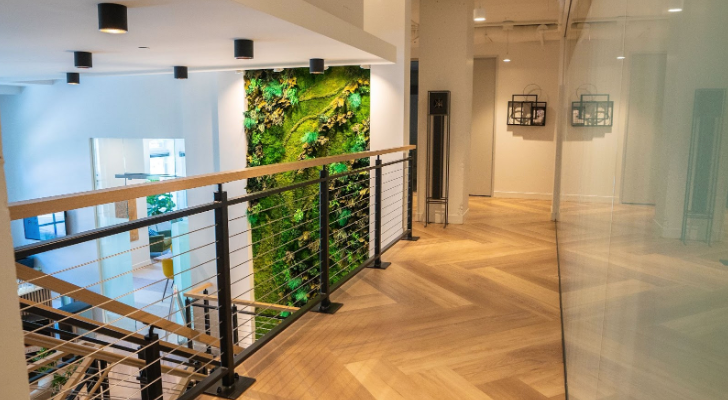 Upstairs hallway with wood flooring and indoor plant wall