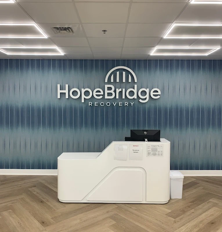 Reception desk in front of blue HopeBridge wall
