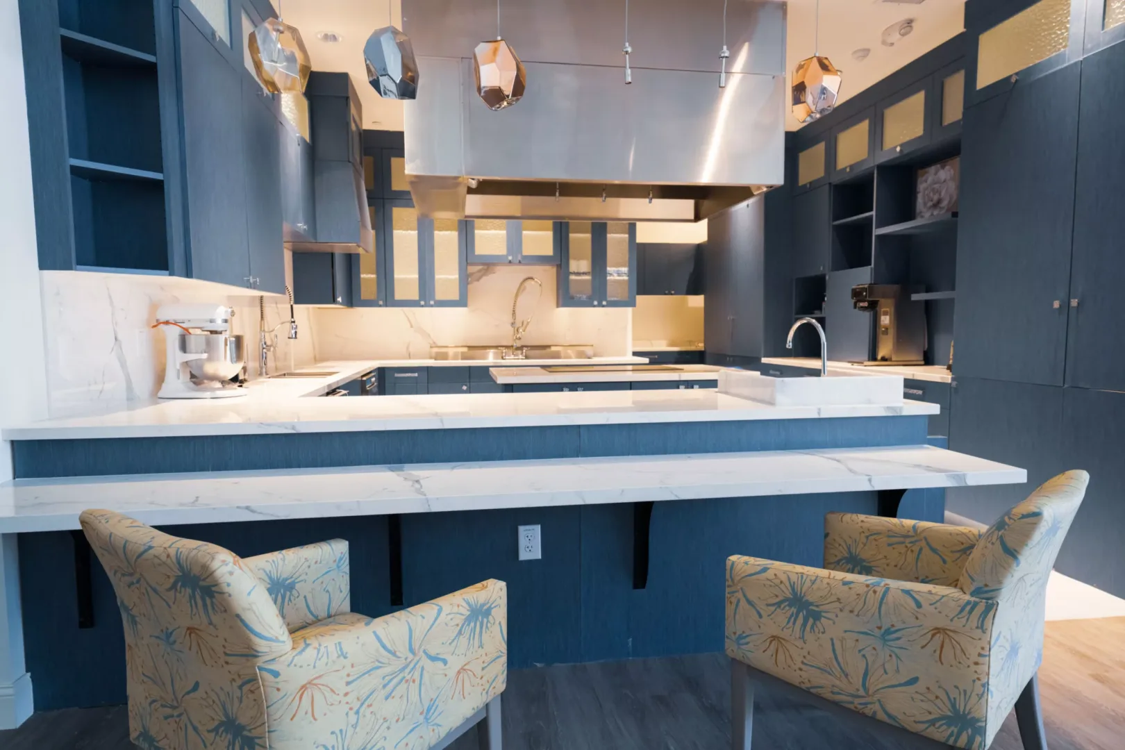 Spacious kitchen with modern appliances and marble countertops.