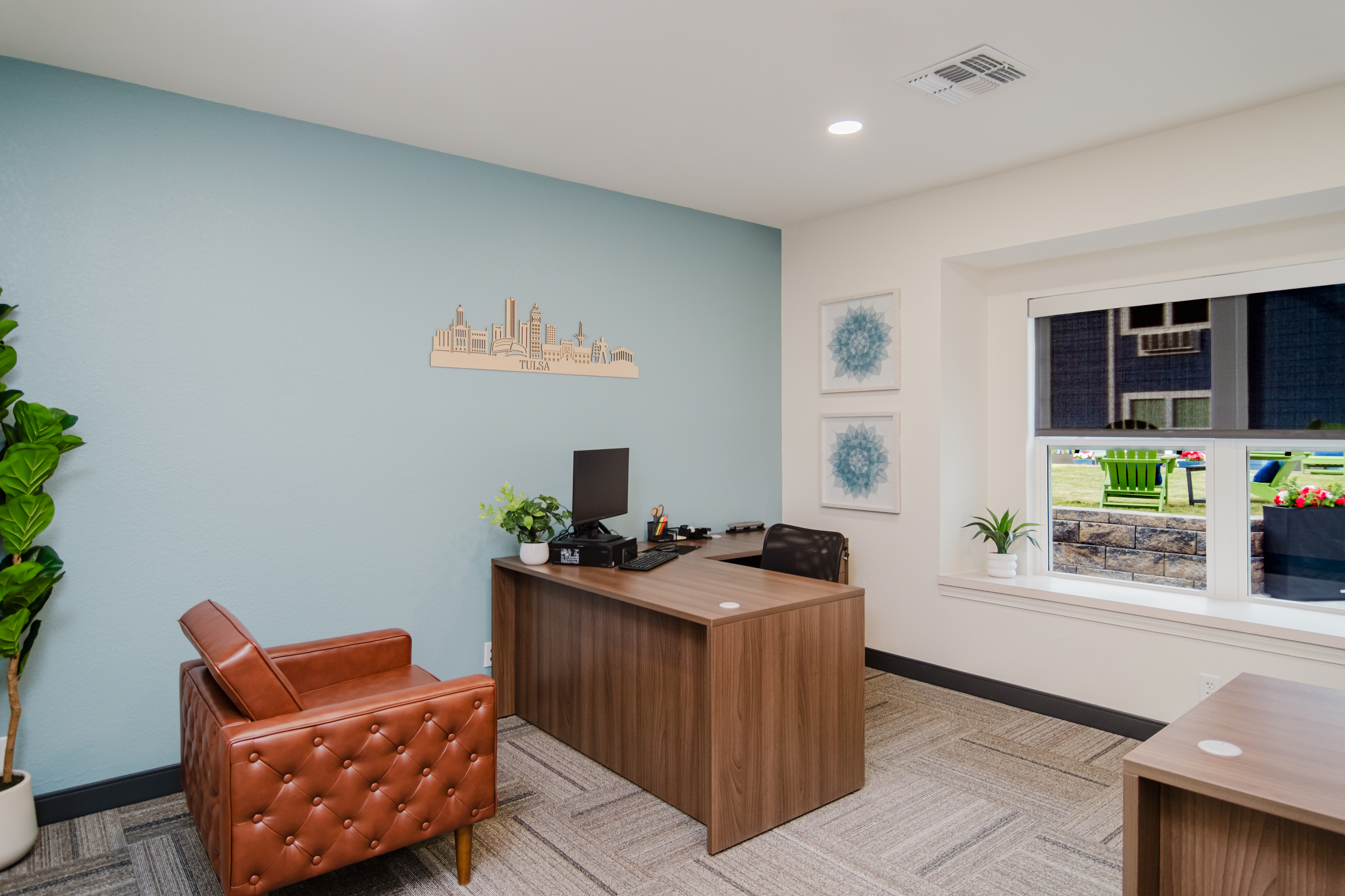 Private office with desk, chair, and natural light.
