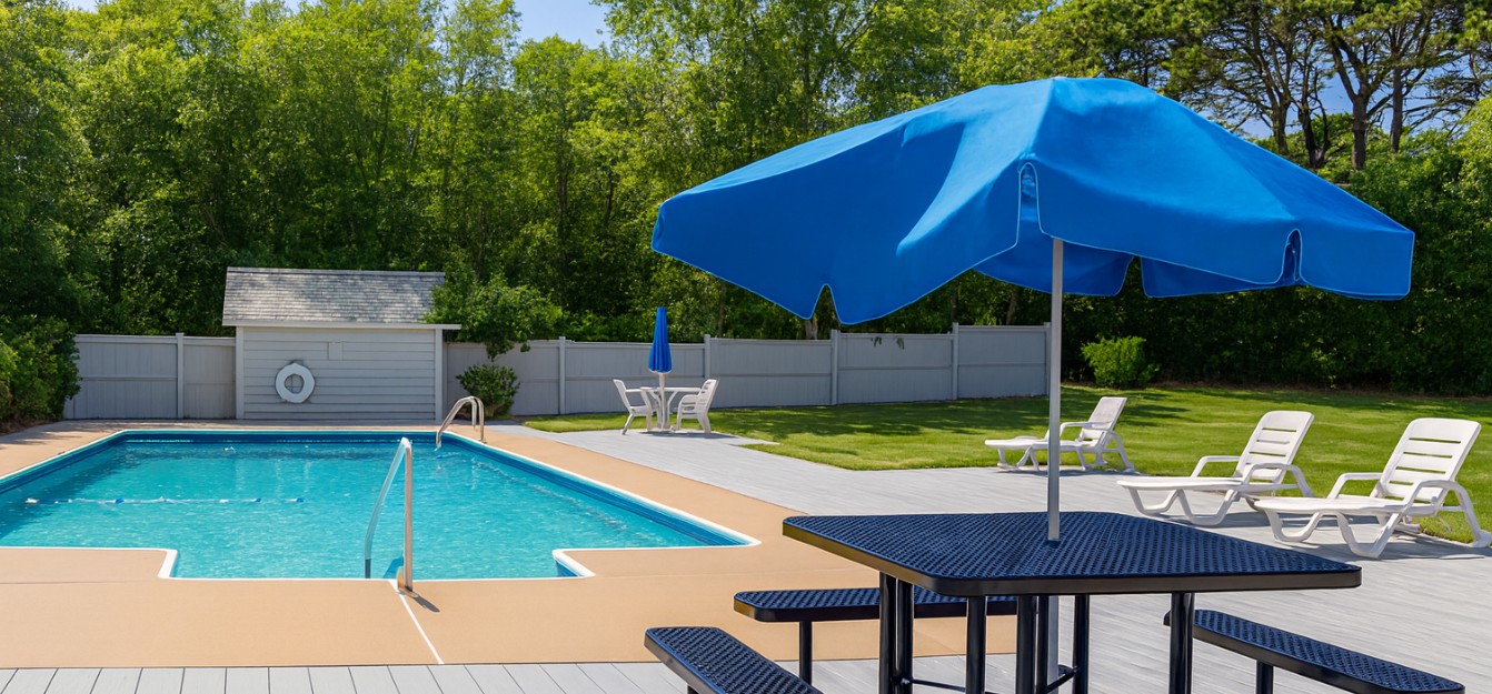 Outdoor pool with lounge chairs and shaded seating area