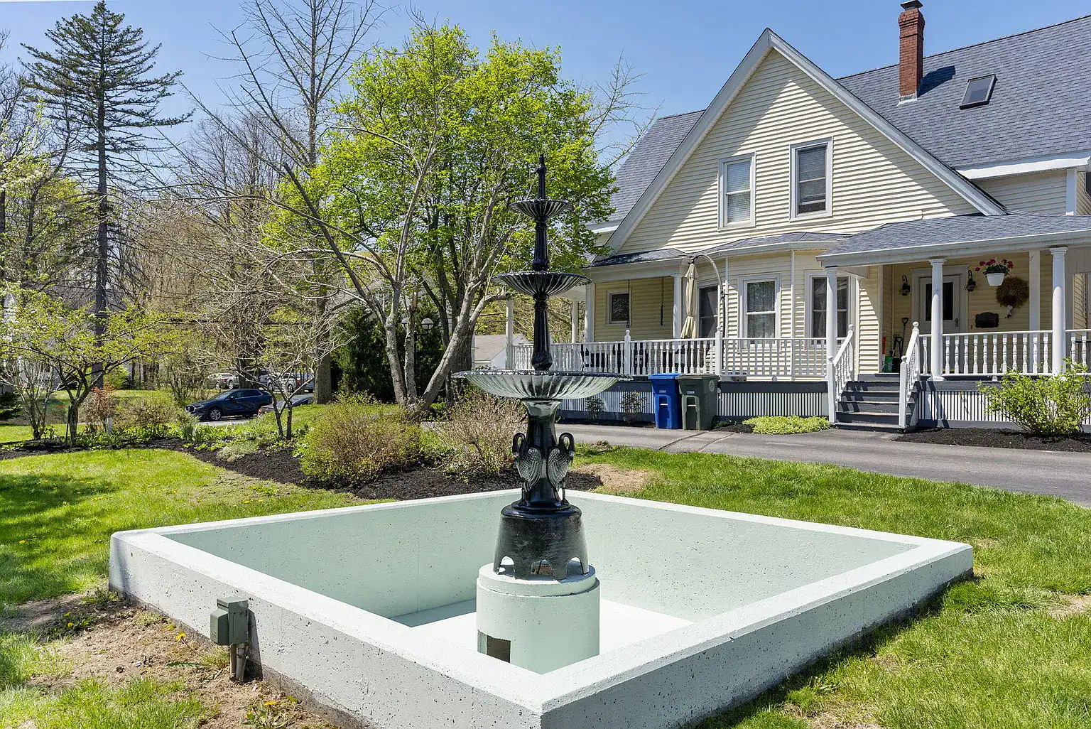 Landscaped courtyard with decorative fountain in front of Southern Maine Recovery campus