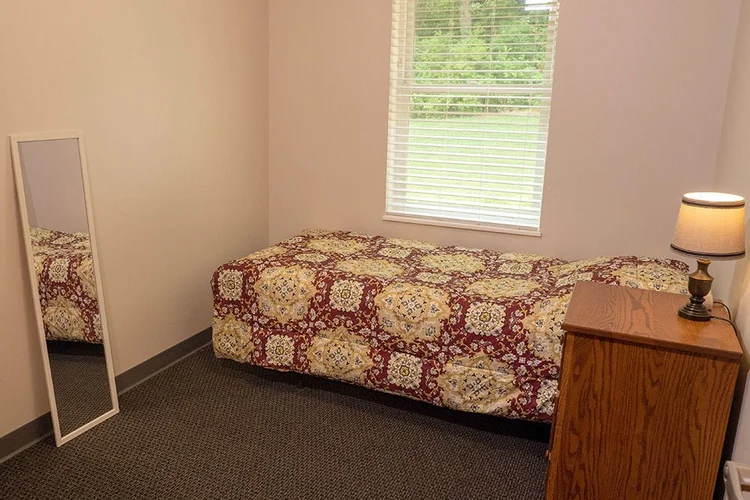 Private bedroom with single bed and nightstand