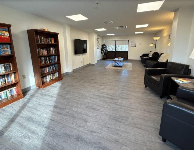 Lounge with bookshelves, chairs, and TV