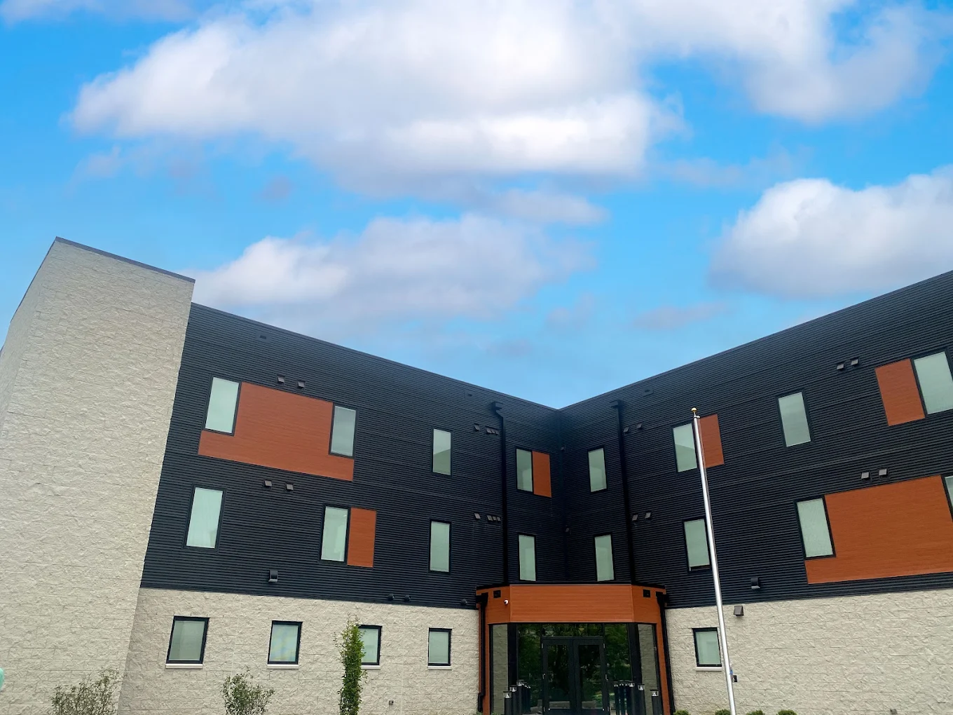 Multi-story building with brick walls and colorful panels