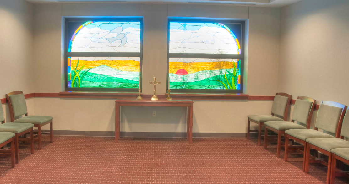 Small chapel with chairs and stained glass windows