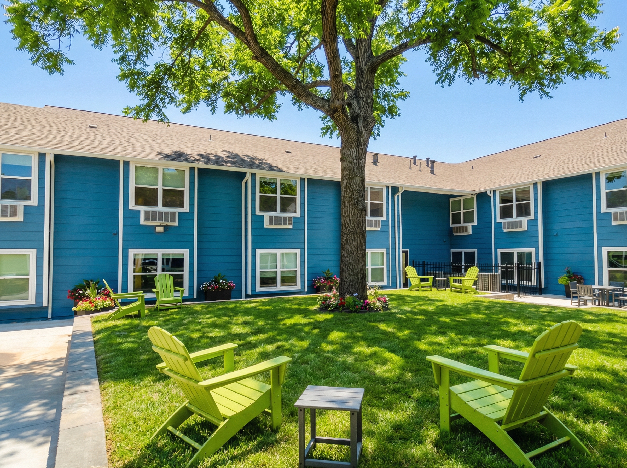 Courtyard with lawn seating and shaded outdoor space.