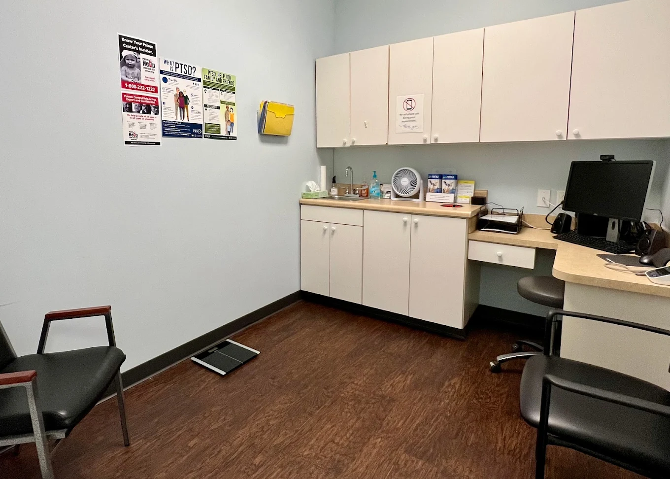 Exam room with sink, cabinets, and scale