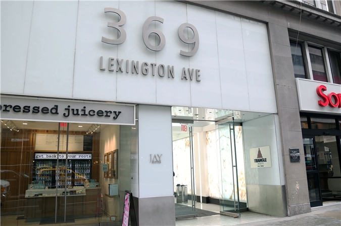Glass entrance at 369 Lexington Ave with signage.