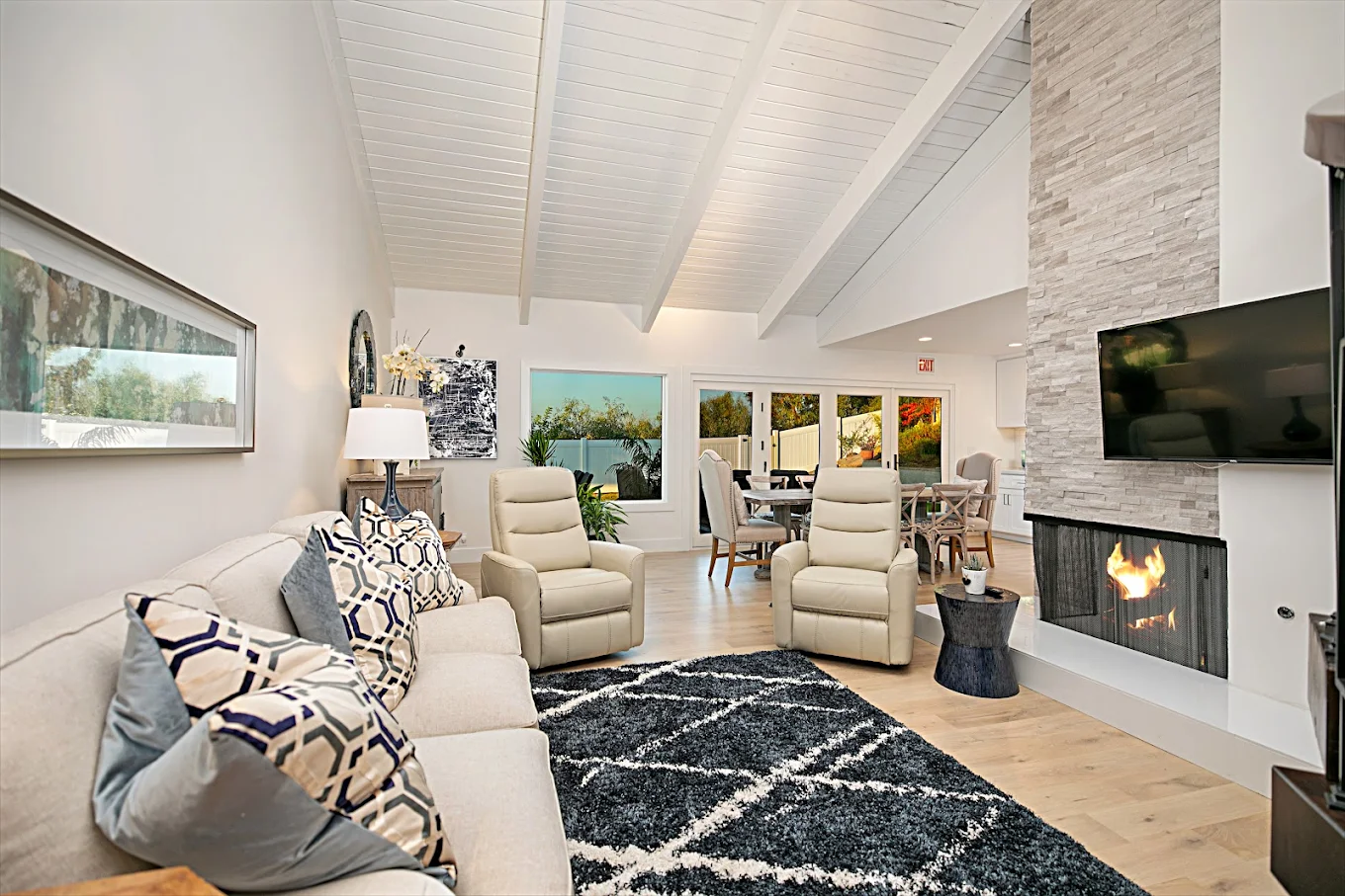 Open living room with fireplace and patio access