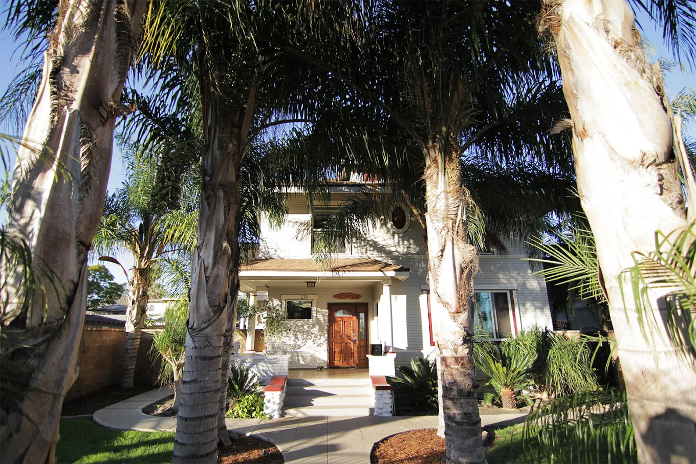 Front entrance of His House 9th Street with palm trees