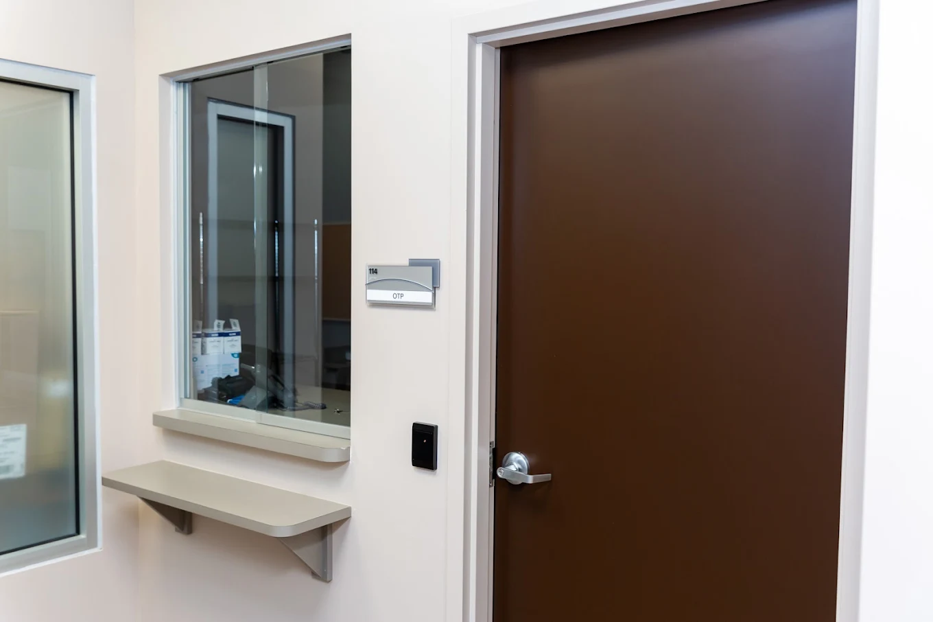 BrightView Danville treatment center dispensing window beside a secured clinical room door