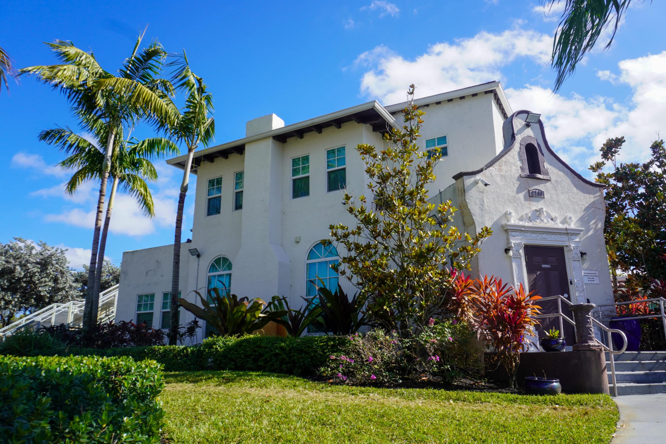 Historic-style rehab building surrounded by gardens