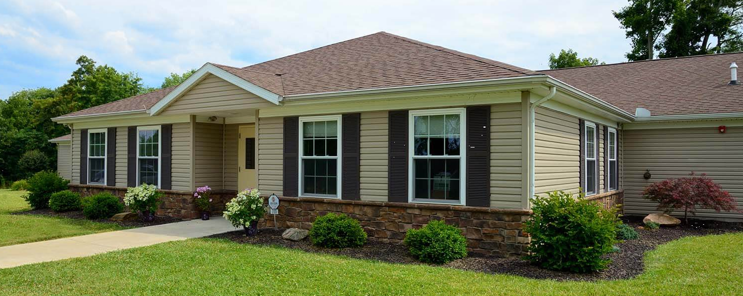 Single-story rehab building exterior with walkway and landscaping