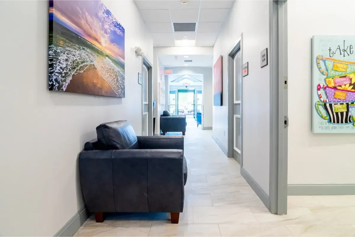 Bright hallway with artwork and seating.