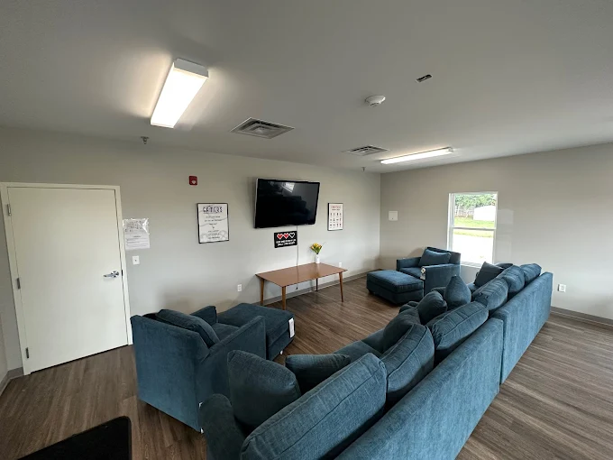 Cozy lounge with blue sofas and wall-mounted TV