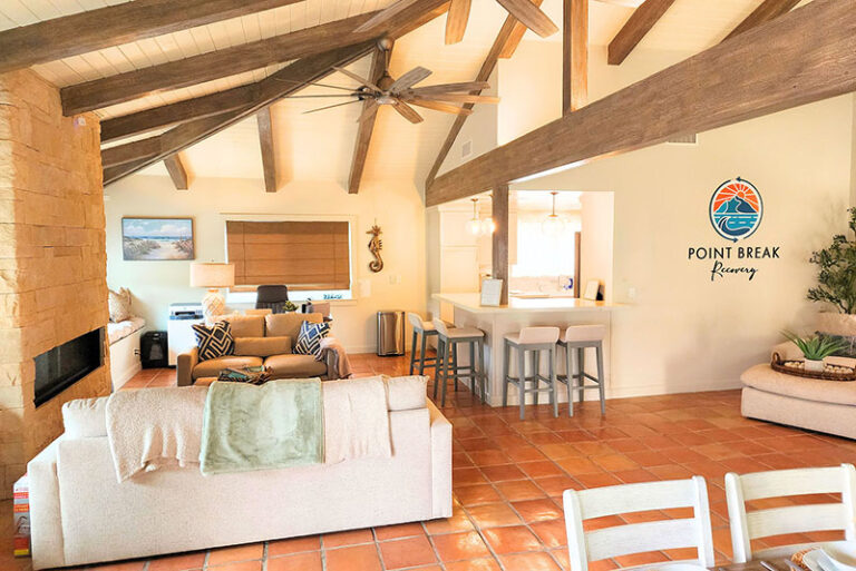 Cozy seating area with stone fireplace and beams