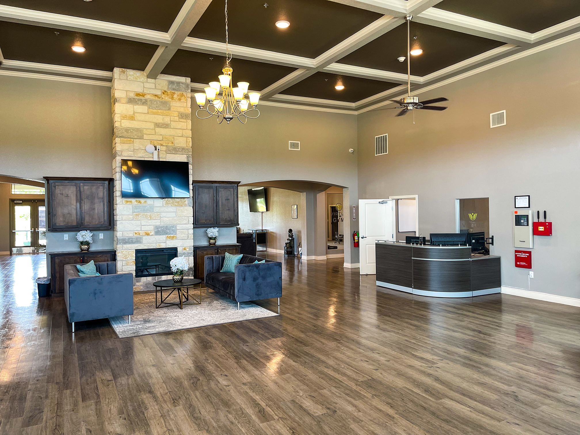 Reception desk with waiting area seating and TV alongside.