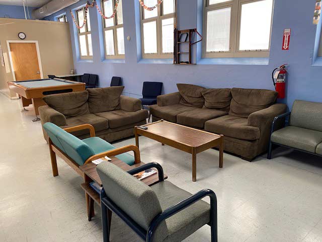 Lounge area with couches and pool table for recreation