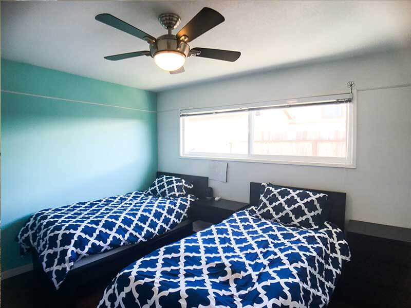 Two twin beds with blue geometric bedding