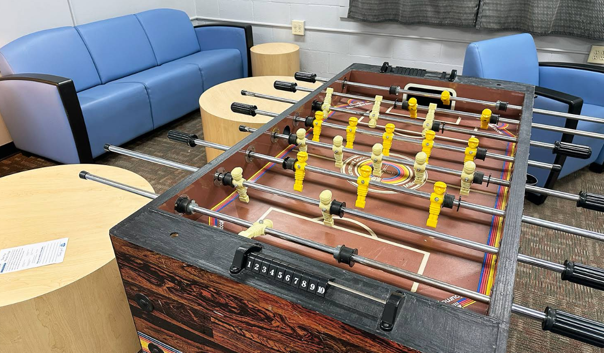 Foosball table in a shared indoor recreation lounge