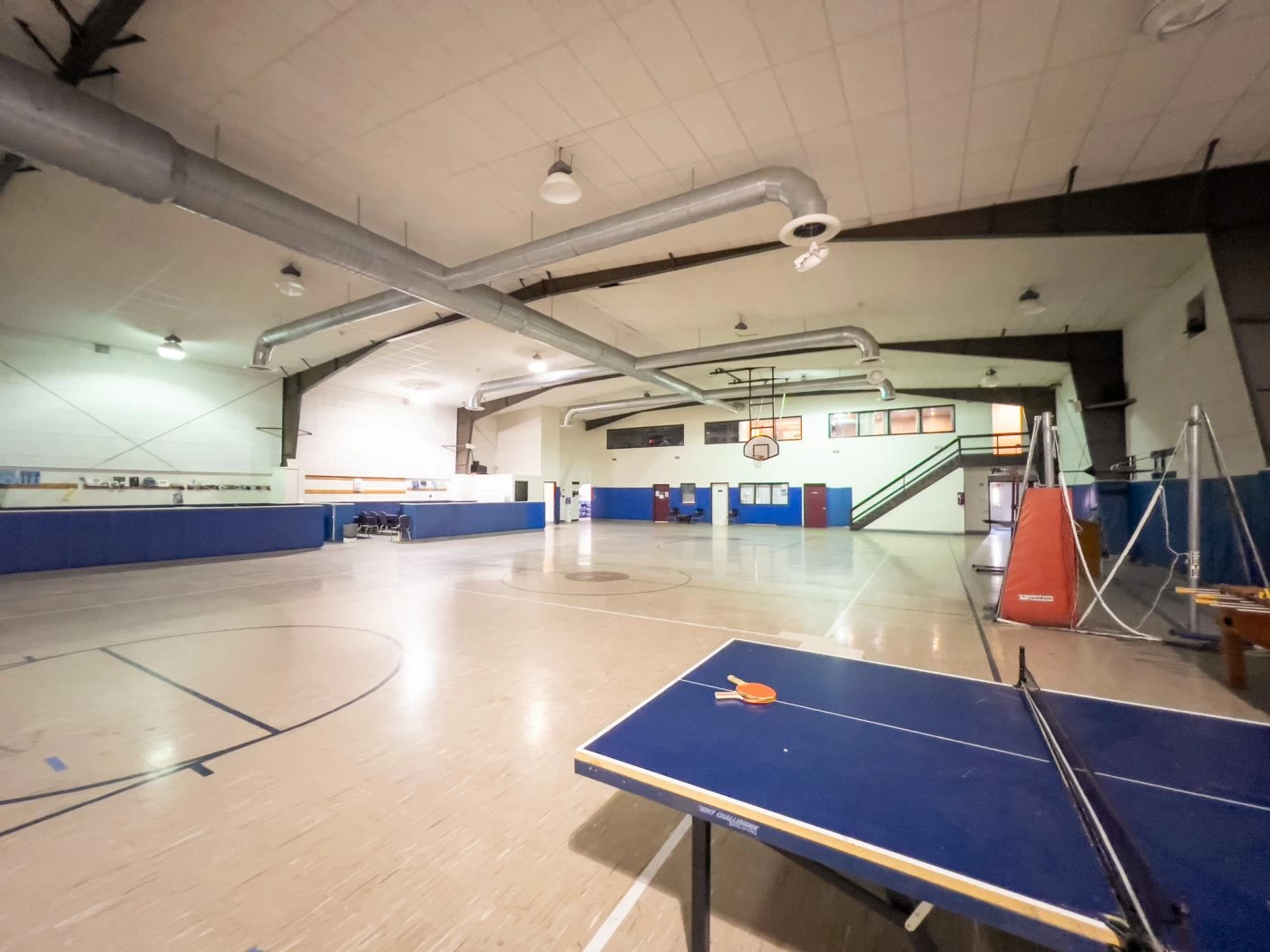 Indoor basketball court with ping pong and seating