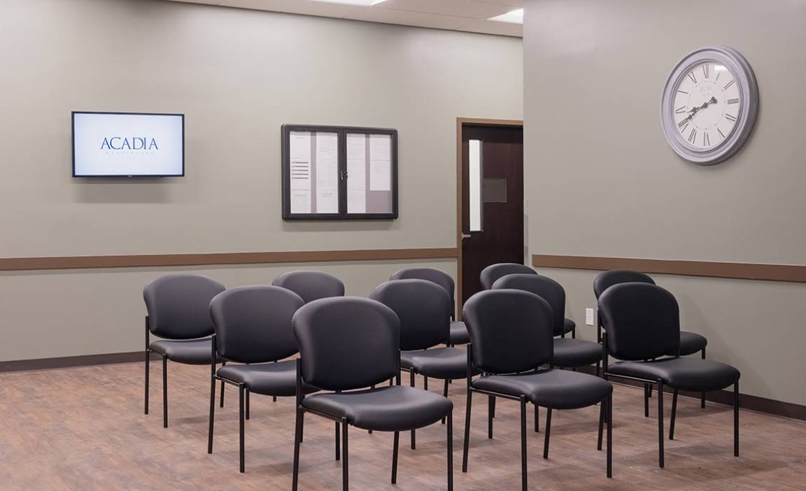 Group room with rows of chairs and wall clock