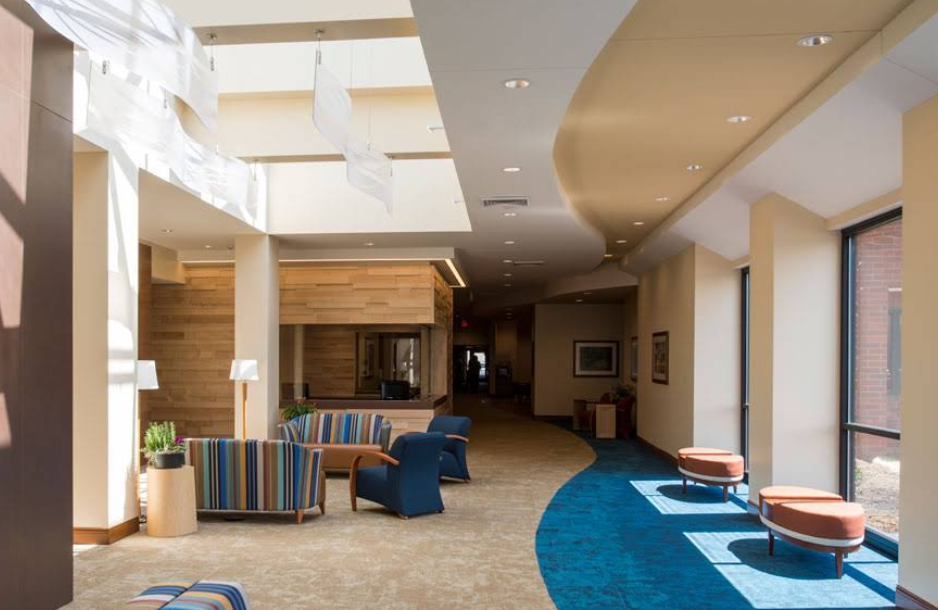 Bright lobby with cushioned chairs and large windows