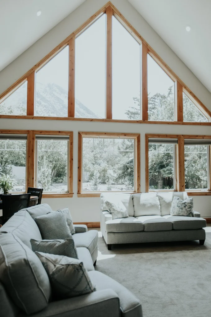 Bright lodge living room with large windows and mountain views
