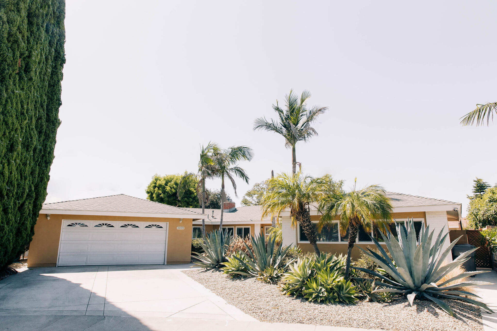 Front of single-story home with desert landscaping