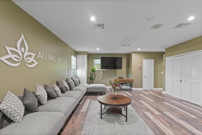 Lounge with long gray sectional and mounted TV
