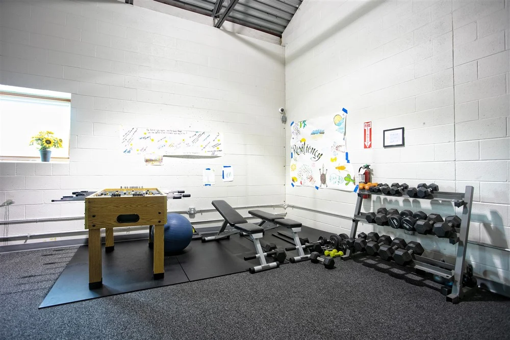 Fitness room with weights, benches, and exercise equipment