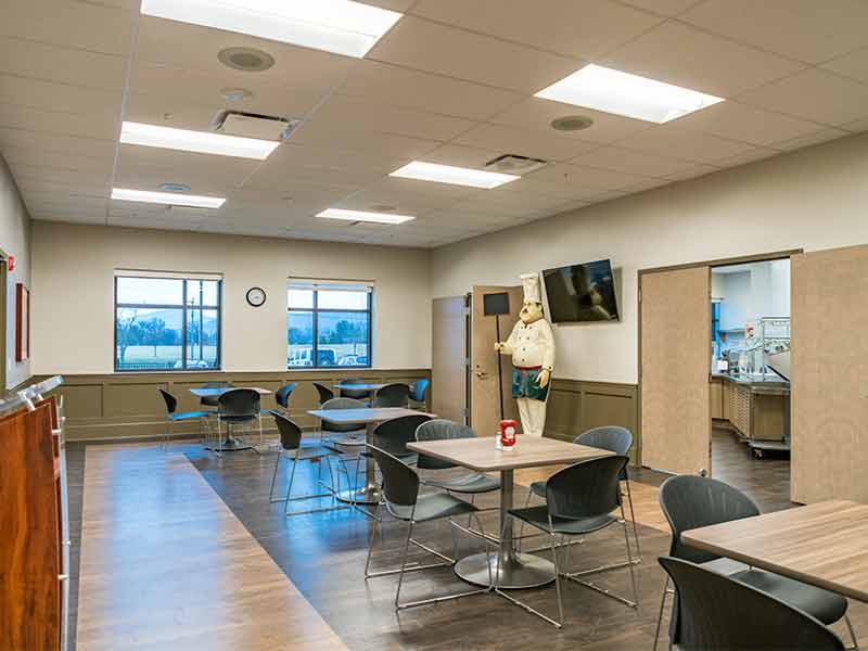 Community dining room with tables and seating inside recovery center