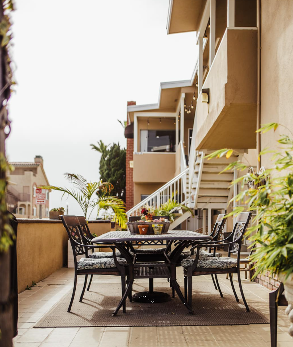 Outdoor patio with dining table and potted plants