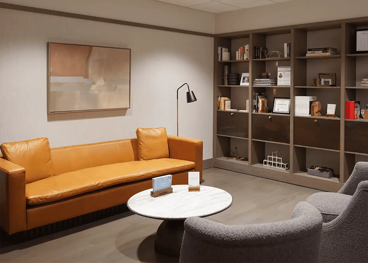 Leather couch and bookshelf in rehab reception area