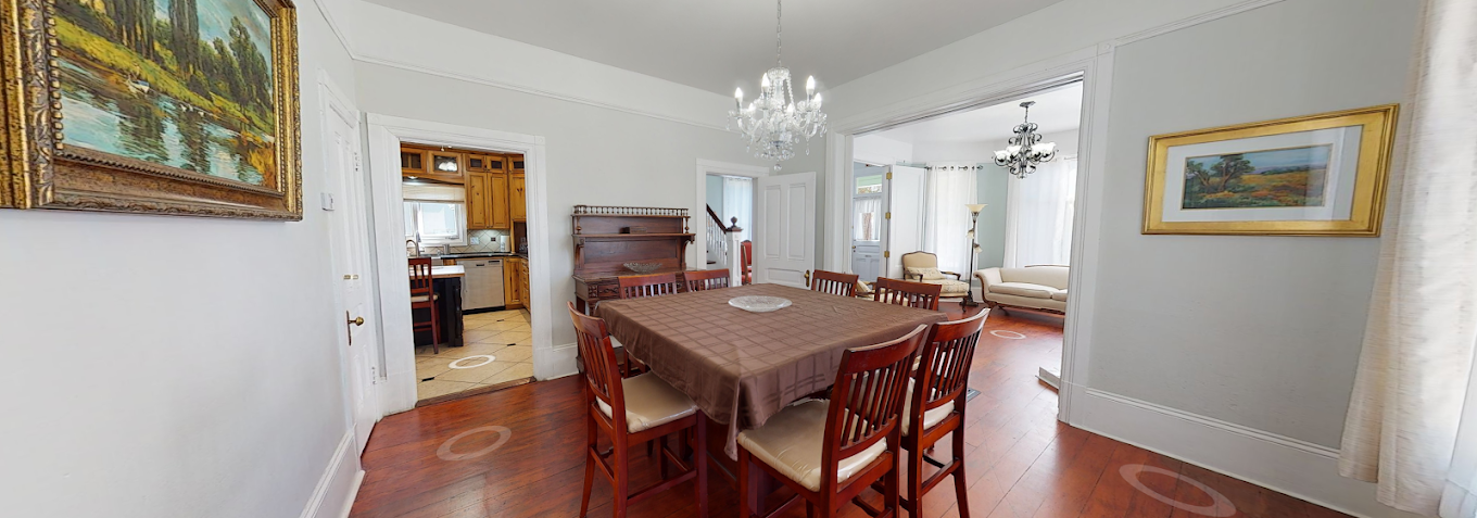 Dining room with communal table and adjoining living spaces