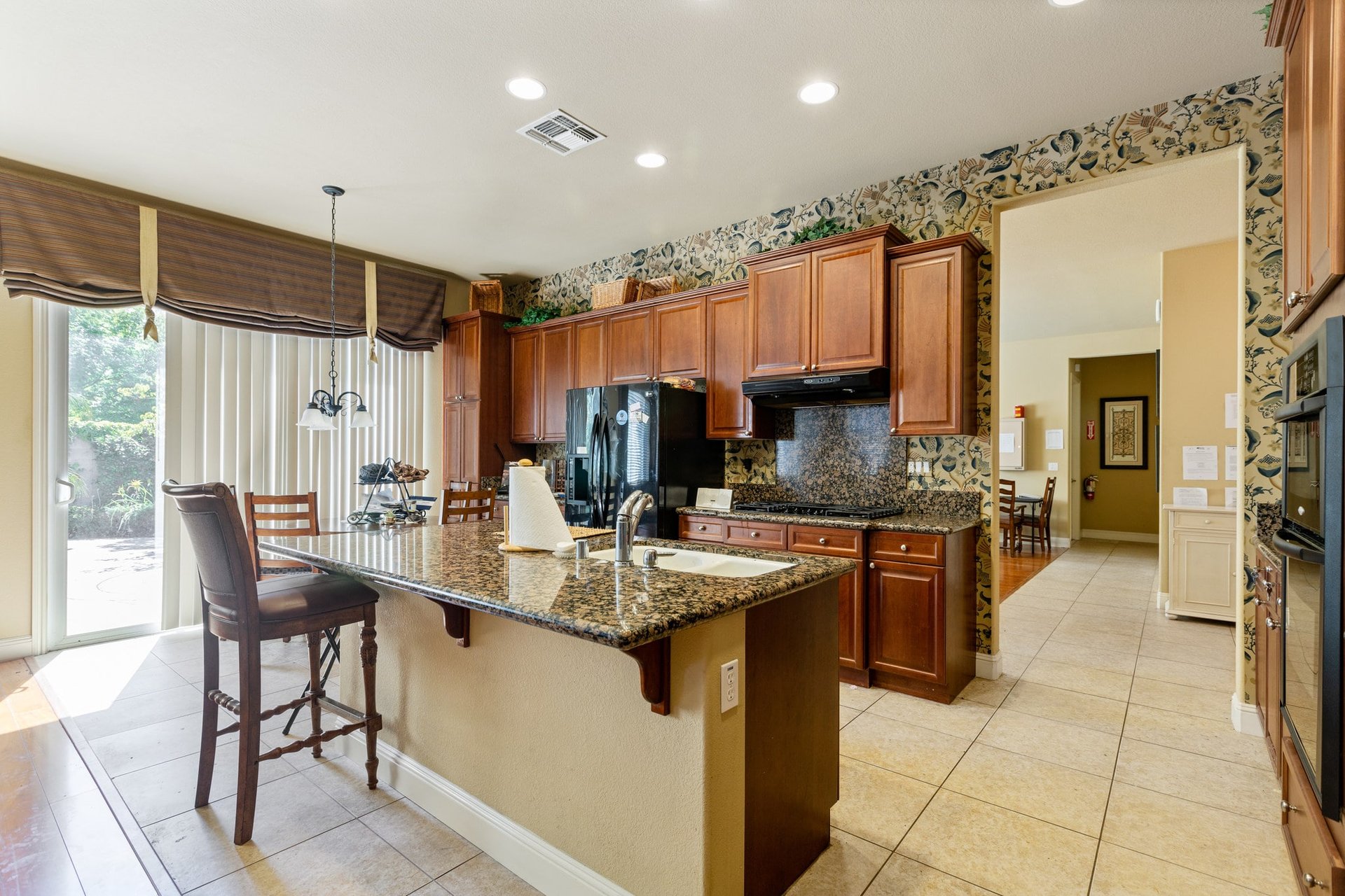 Granite kitchen island with chairs and large cabinets