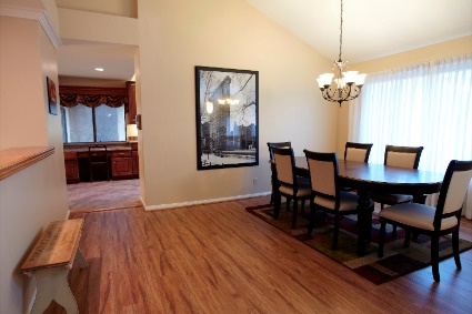 Dining area with large table and eight chairs near kitchen