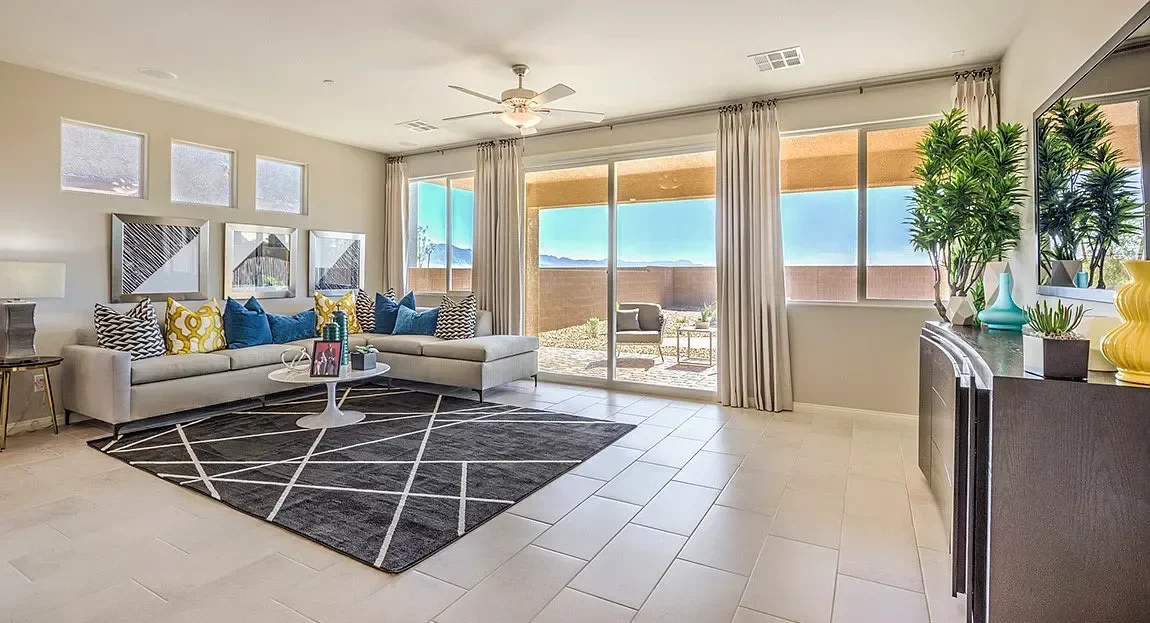 Living room with large windows and a view of outdoor patio