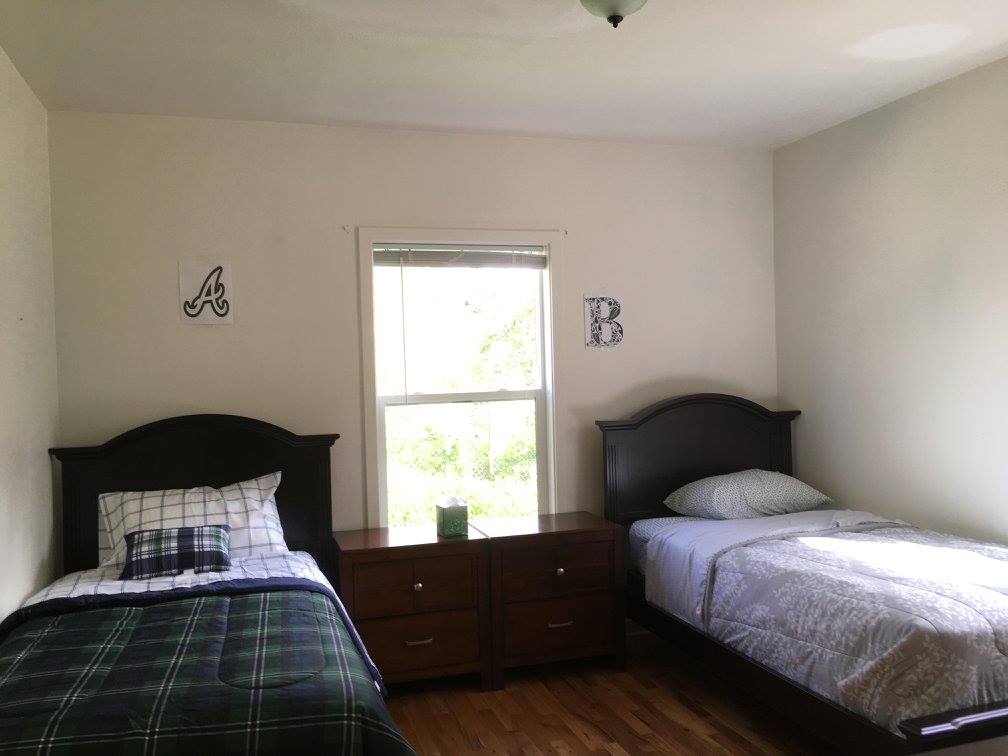 Shared bedroom with two twin beds and natural light