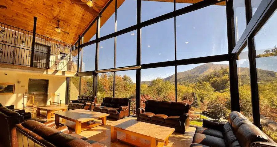 Group lounge with sofas and mountain views through tall windows