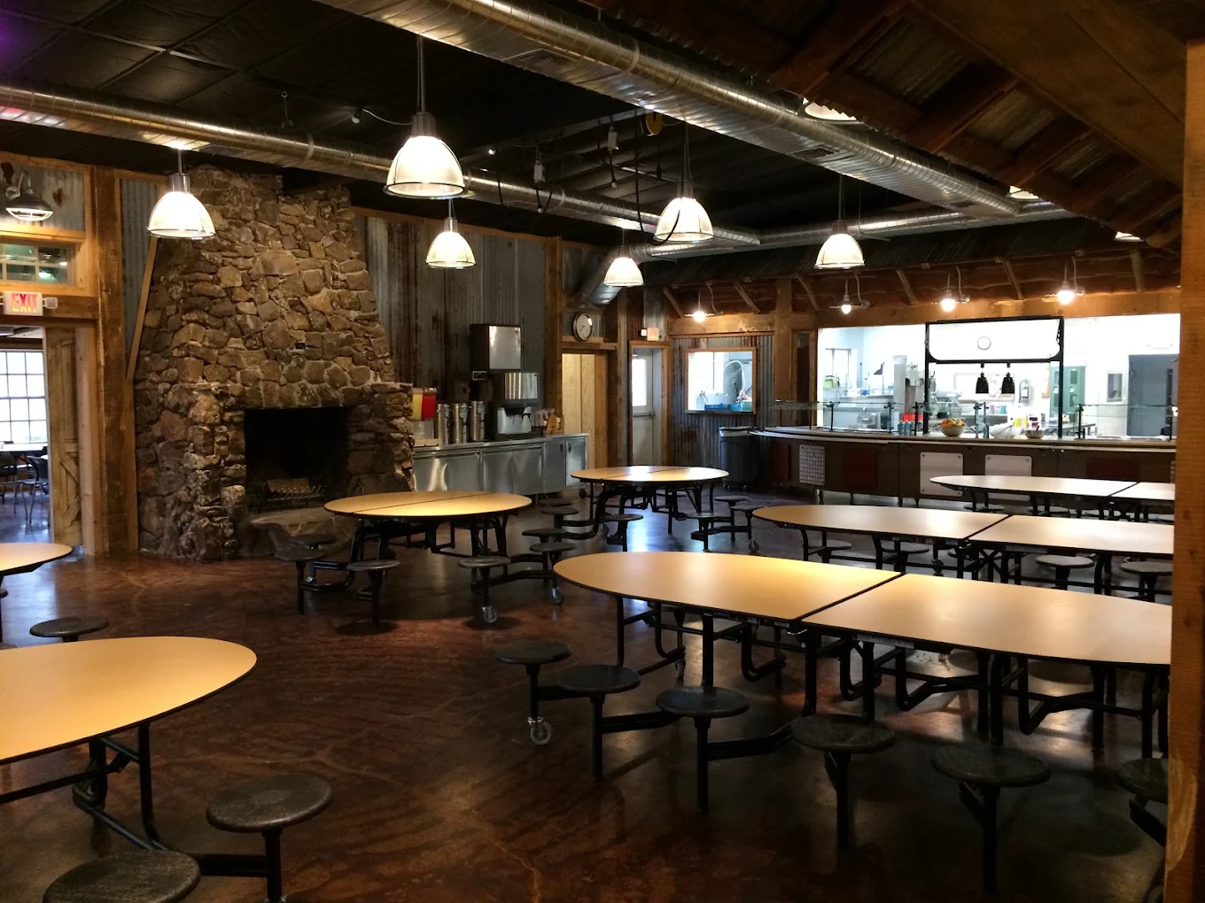 Cafeteria with long tables and on-site food service area