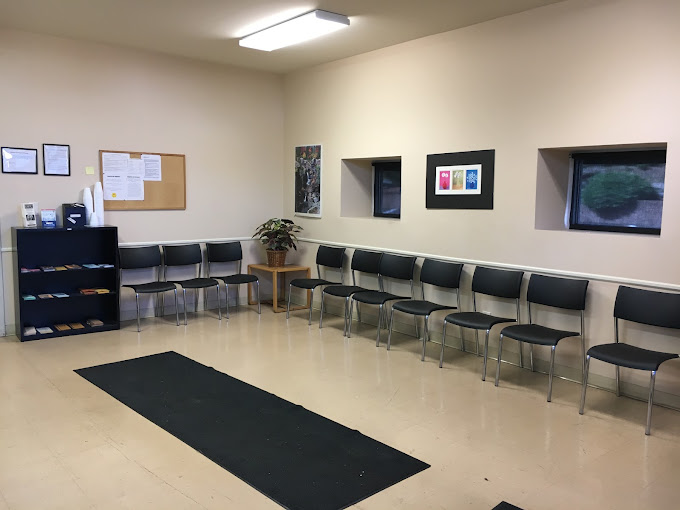 Waiting area with chairs, a bulletin board, and brochures.