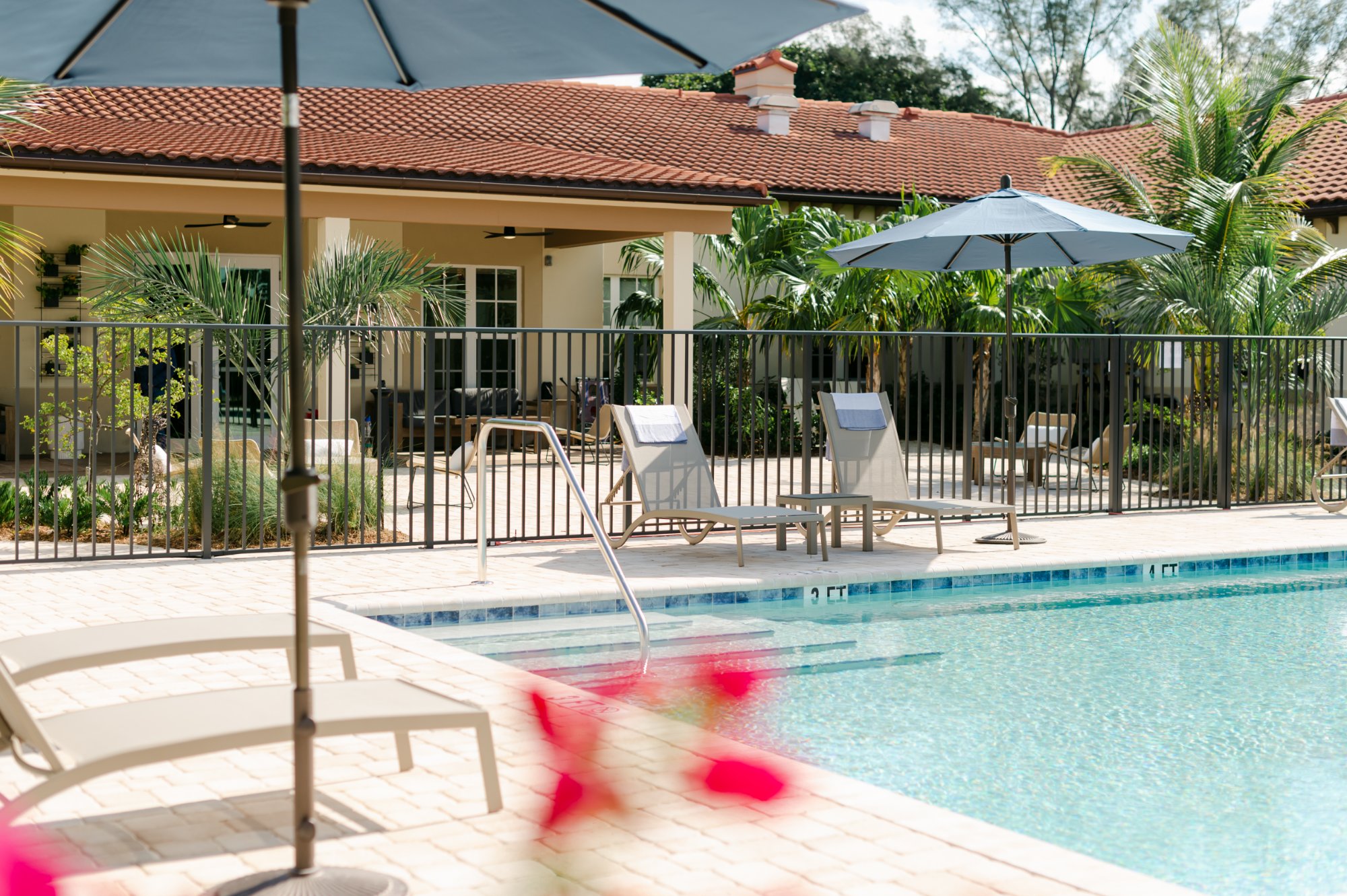 Outdoor pool with lounge chairs and umbrellas