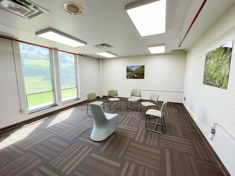 Bright group therapy room with chairs arranged in a circle