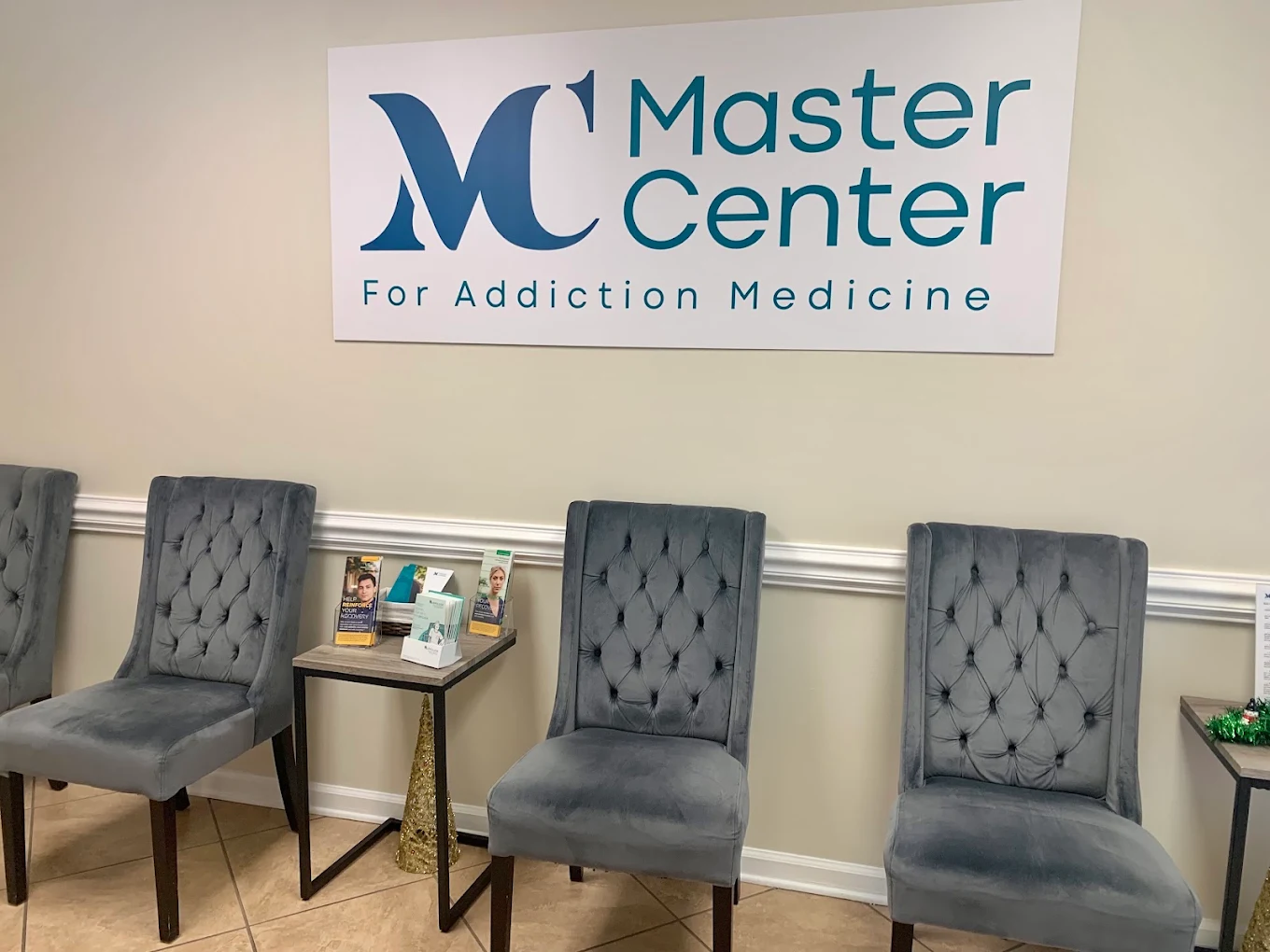 Waiting area with upholstered chairs and facility sign